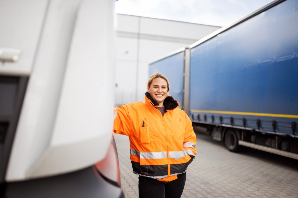 Egertons team member in high-visibility workwear standing beside an articulated lorry.