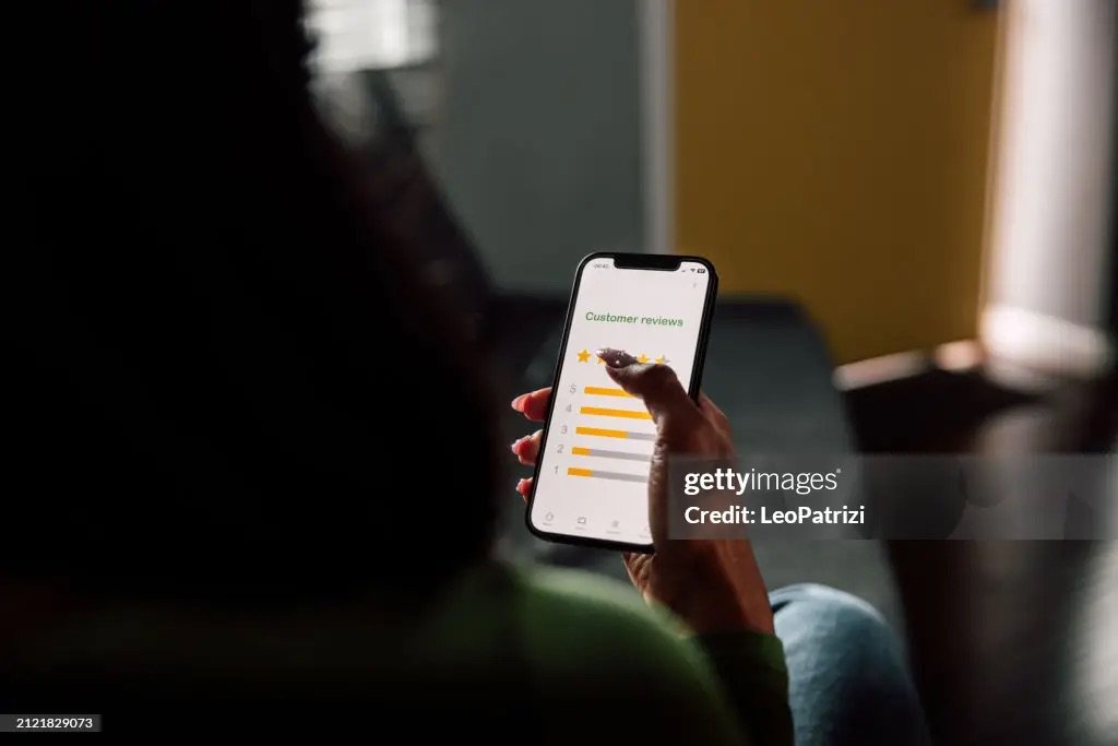 Customer reading a review on a mobile phone.