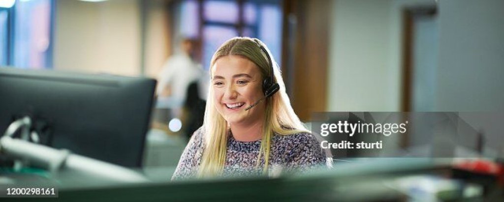 Call handler wearing a headset at her desk.