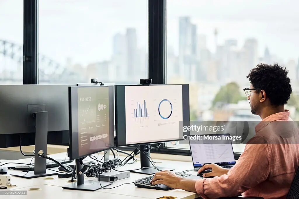 Analyst reviewing fleet data on screens.