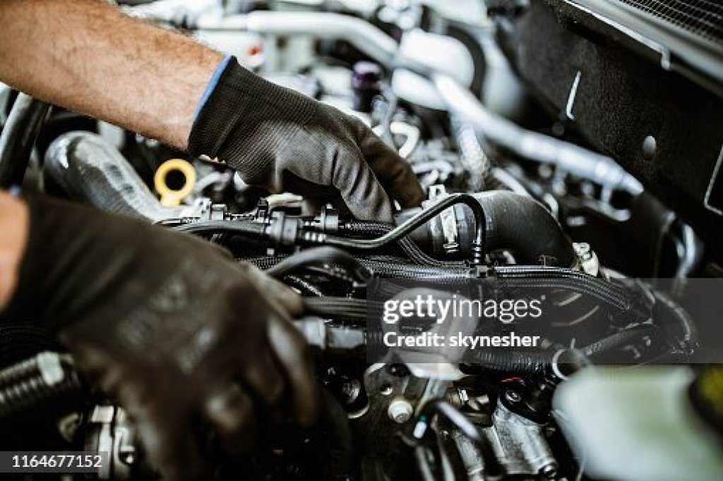 Mobile technician working on an engine.