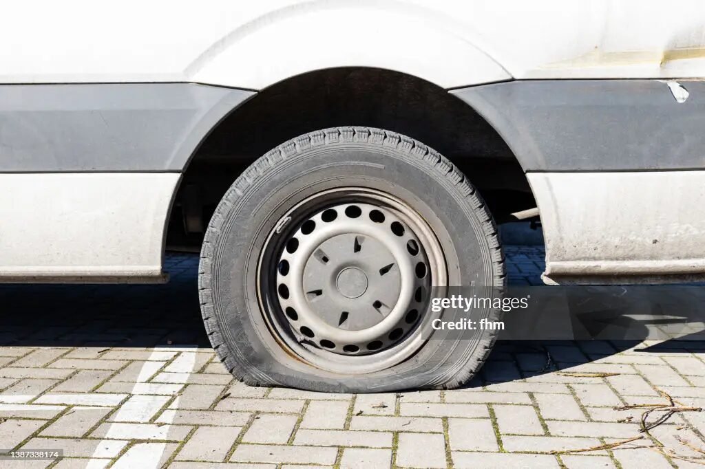 Van with a flat tyre.